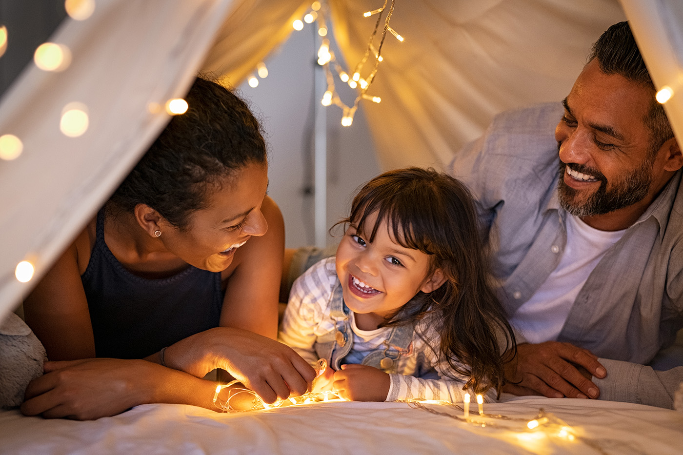 Photo of a family in a child's homemade tent