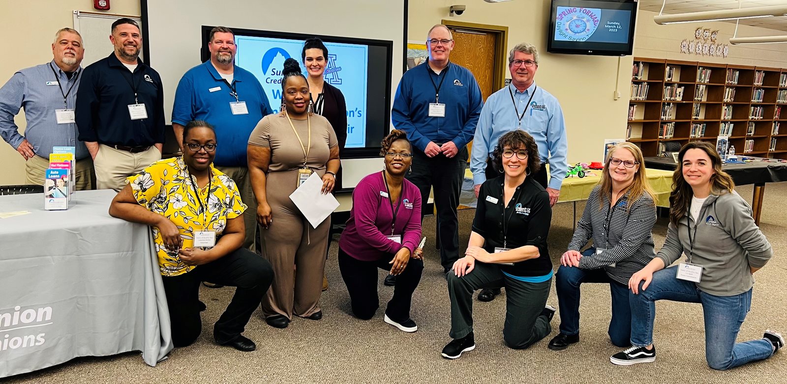 Posed image of staff and volunteers supporting a Taste-of-Reality fair event